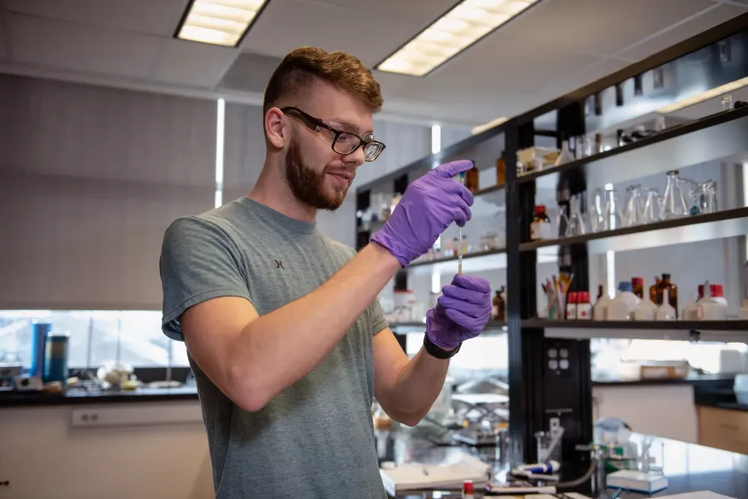 Student performing experiment in chemistry lab